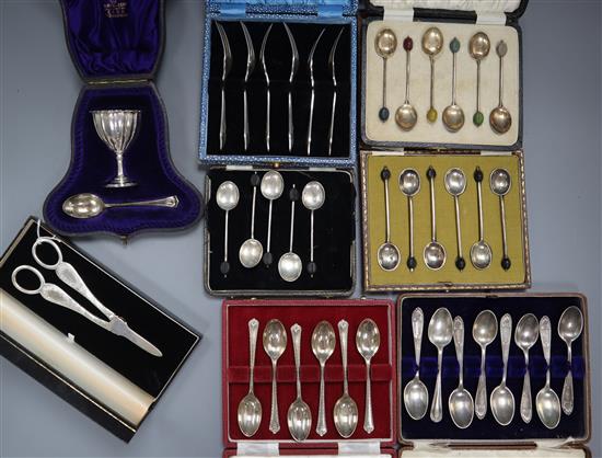 Seven cased sets/part sets of silver flatware including silver and enamel coffee spoon and a pair of modern silver grape shears etc.